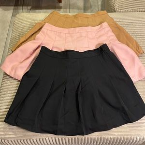 Three pleated skirts